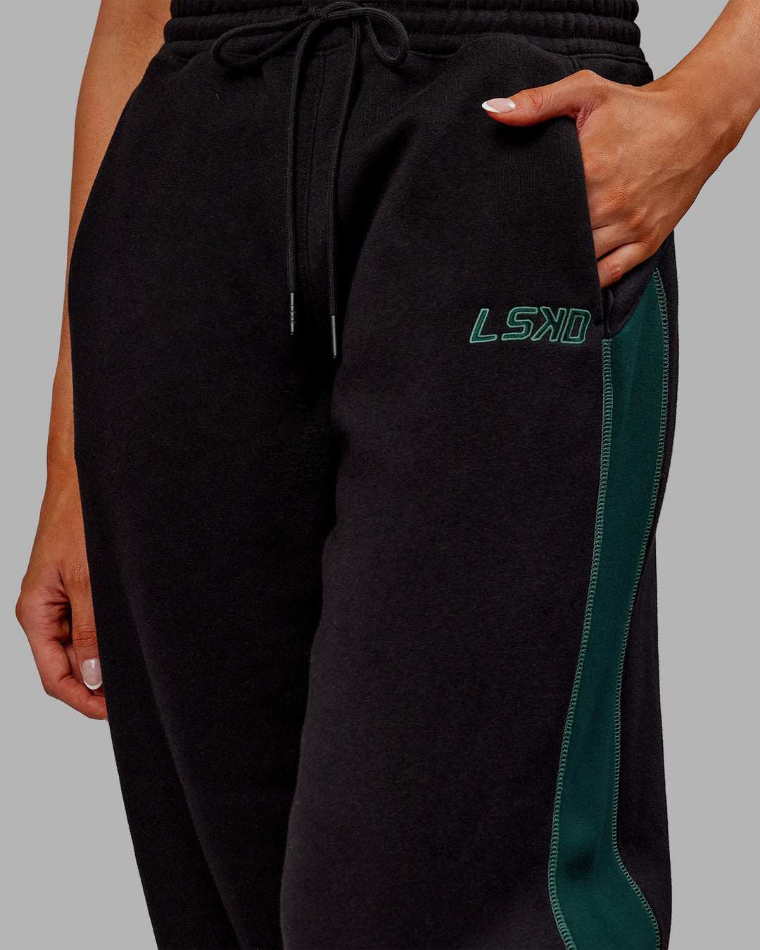 Woman wearing Stitch Up Fleece Sweat Pant - Black/Dark Moss | Model:Ella | Size:S