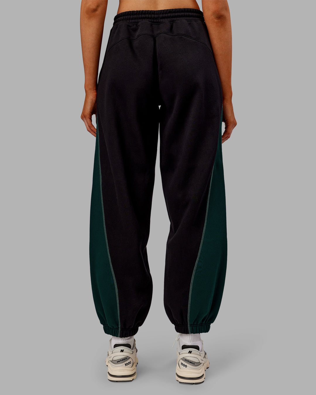 Woman wearing Stitch Up Fleece Sweat Pant - Black/Dark Moss | Model:Ella | Size:S