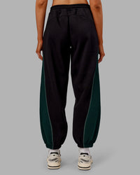 Woman wearing Stitch Up Fleece Sweat Pant - Black/Dark Moss | Model:Ella | Size:S
