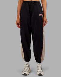 Woman wearing Stitch Up Fleece Sweat Pant - Black/Shale Beige | Model:Ella | Size:S