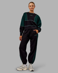 Woman wearing Stitch Up Oversized Fleece Sweater - Black-Dark Moss | Model:Ella | Size:S