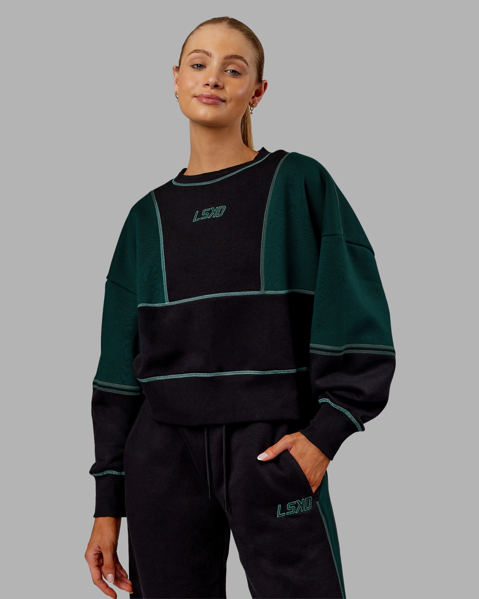 Woman wearing Stitch Up Oversized Fleece Sweater - Black-Dark Moss | Model:Ella | Size:S