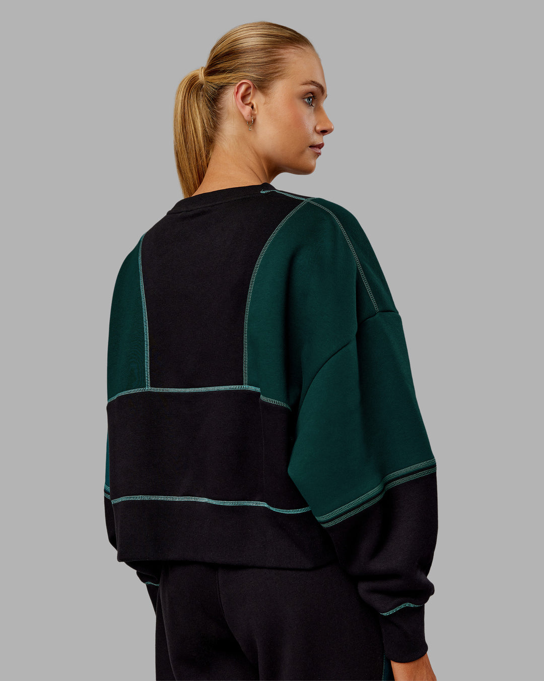 Woman wearing Stitch Up Oversized Fleece Sweater - Black-Dark Moss | Model:Ella | Size:S
