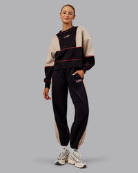 Woman wearing Stitch Up Oversized Fleece Sweater - Black-Shale Beige | Model:Ella | Size:S