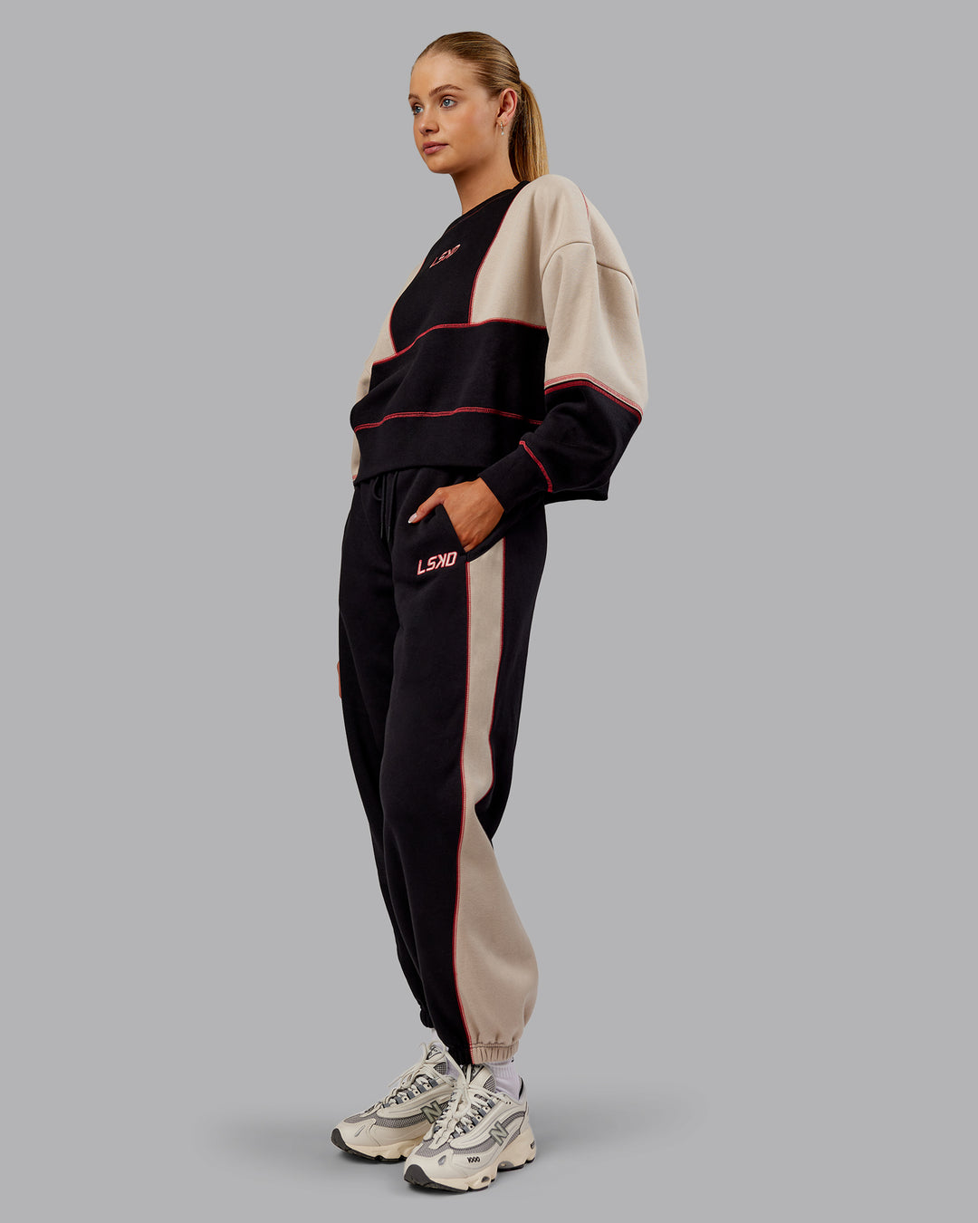 Woman wearing Stitch Up Oversized Fleece Sweater - Black-Shale Beige | Model:Ella | Size:S