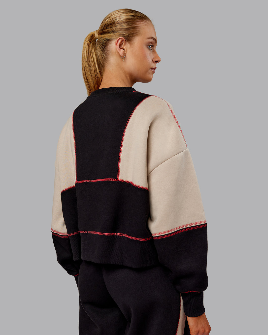 Woman wearing Stitch Up Oversized Fleece Sweater - Black-Shale Beige | Model:Ella | Size:S