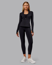 Woman wearing Stride Thermal Zip Through Jacket - Black | Model:Ella | Size:S