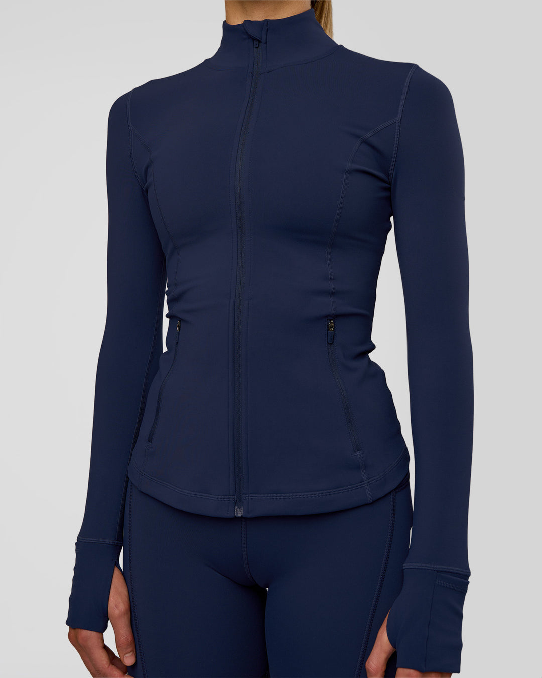 Woman wearing Stride Zip Through Jacket - Future Navy | Model:Evie | Size:S