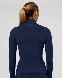 Woman wearing Stride Zip Through Jacket - Future Navy | Model:Evie | Size:S