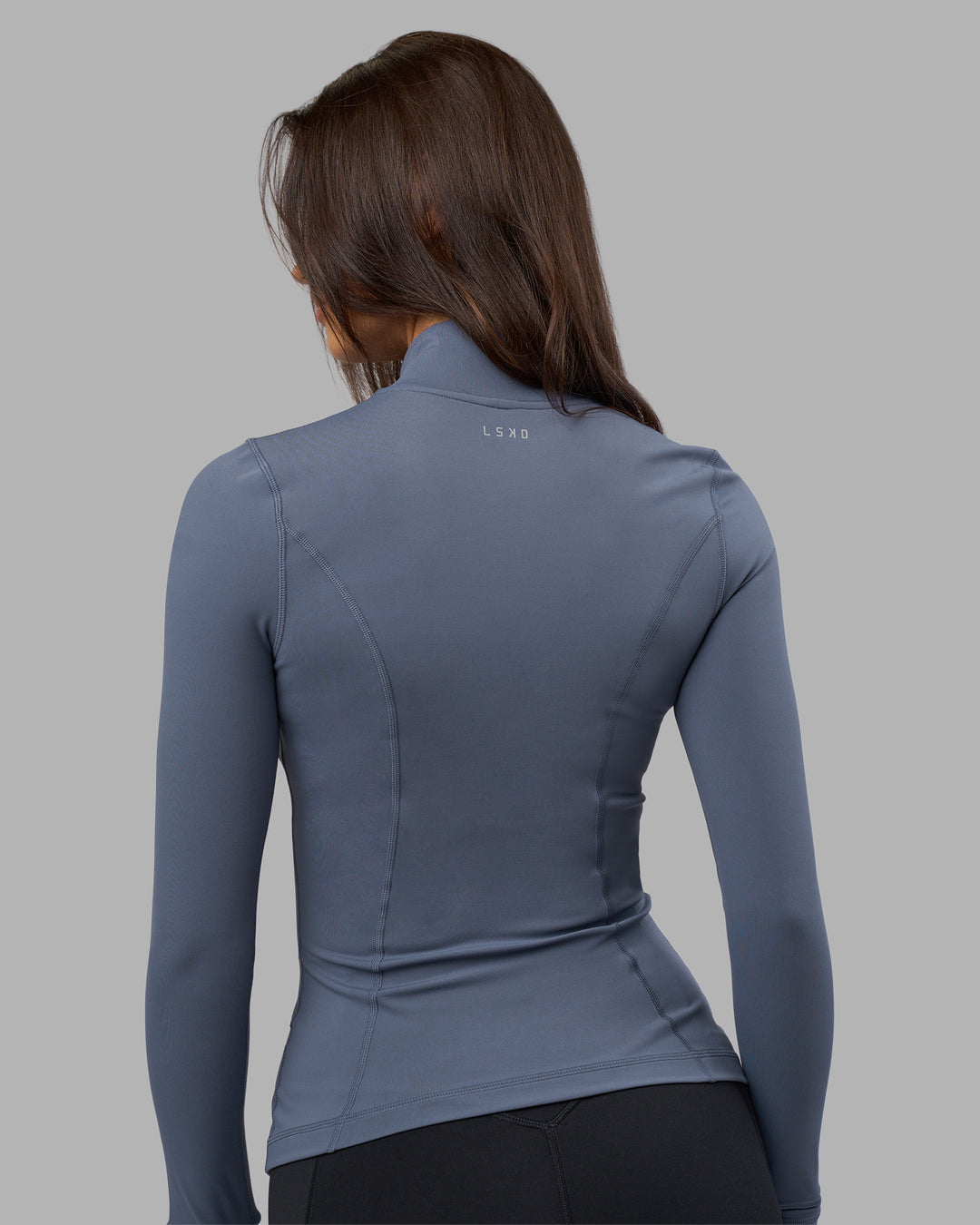 Woman wearing Stride Zip Through Jacket - Night Shadow | Model:Phoebe | Size:S