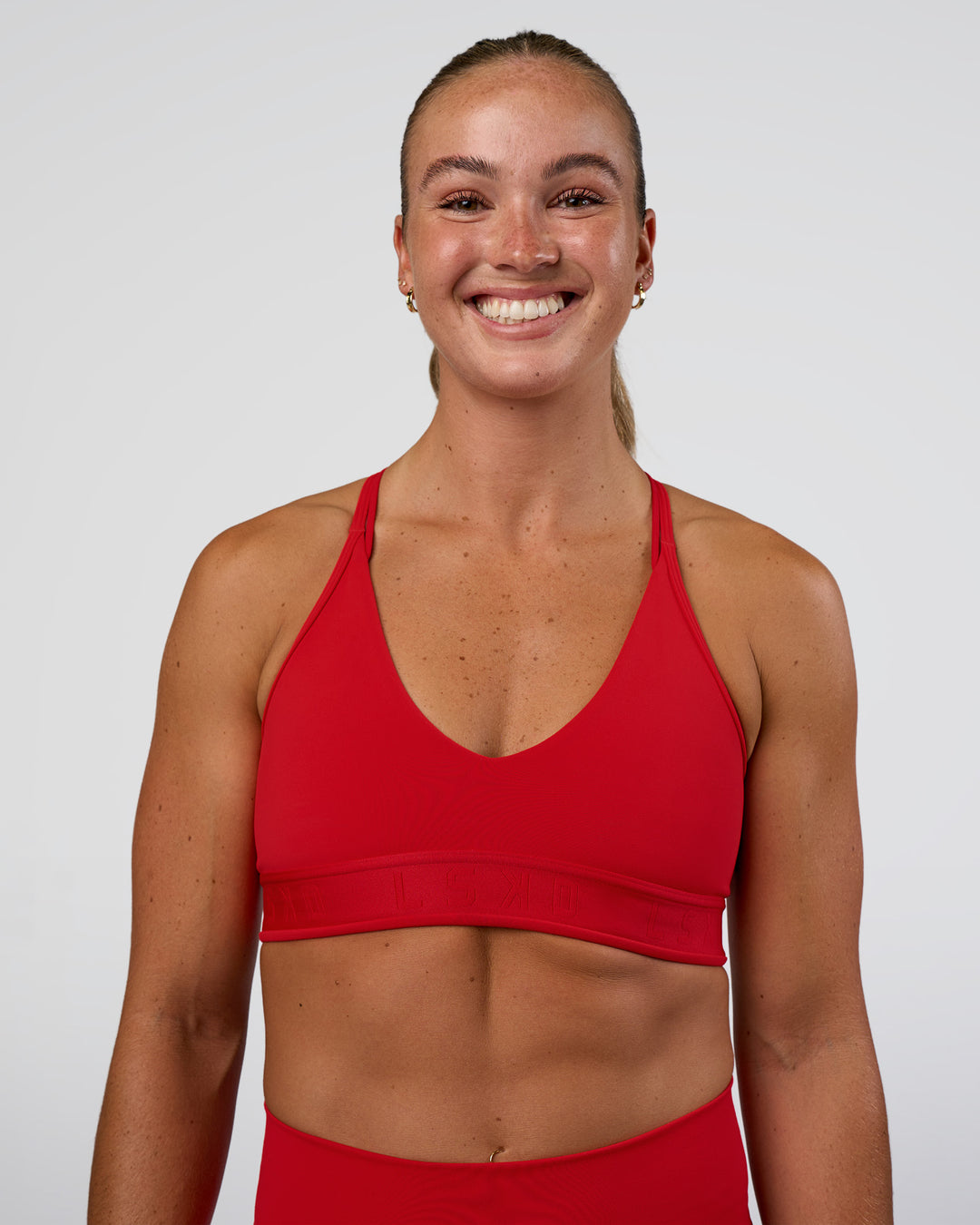 Woman wearing Strive Jacquard Sports Bra - Flame | Model:Sav | Size:S
