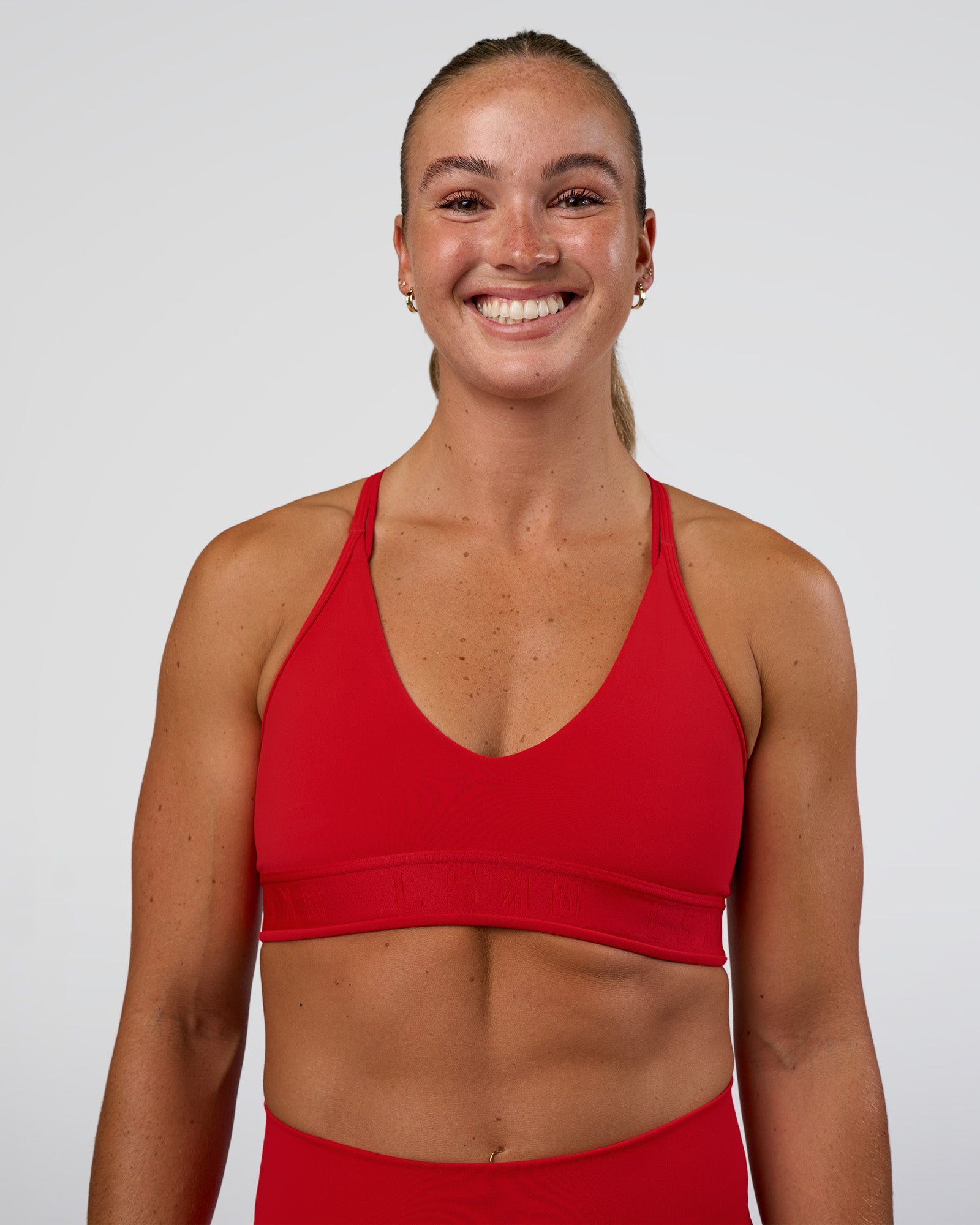 Woman wearing Strive Jacquard Sports Bra - Flame | Model:Sav | Size:S