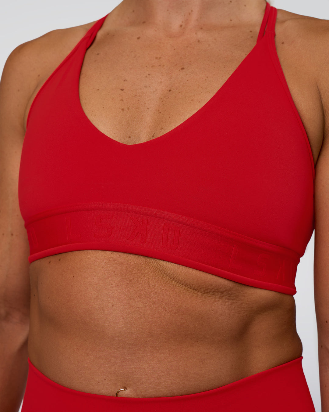 Woman wearing Strive Jacquard Sports Bra - Flame | Model:Sav | Size:S