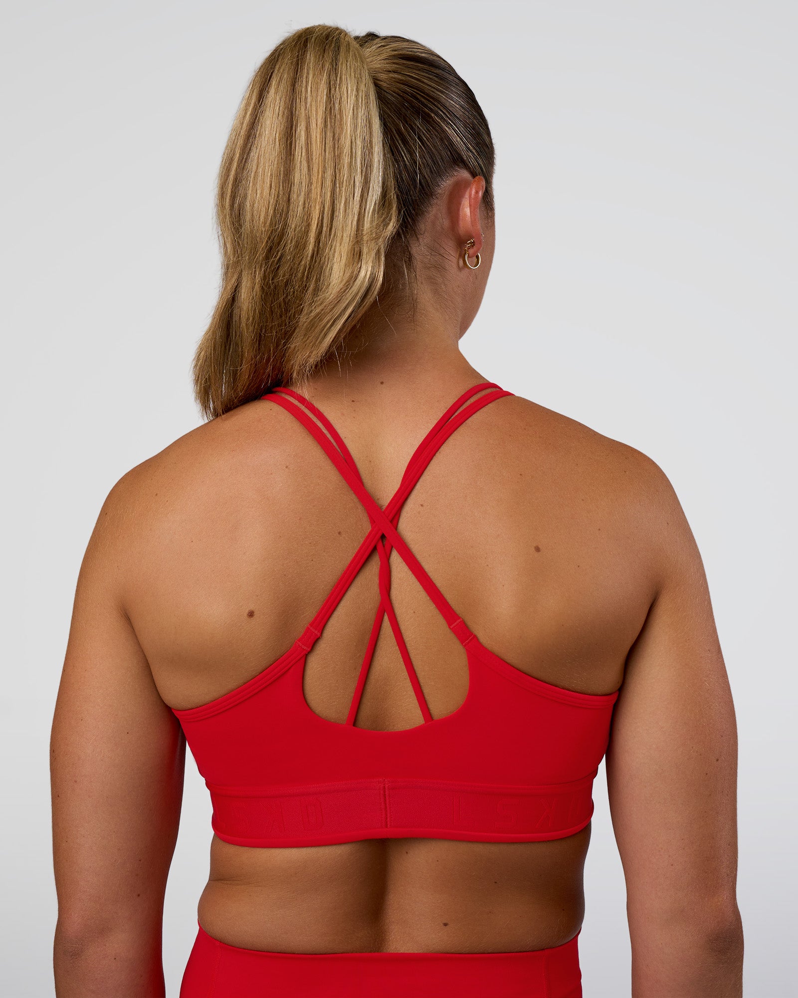 Woman wearing Strive Jacquard Sports Bra - Flame | Model:Sav | Size:S