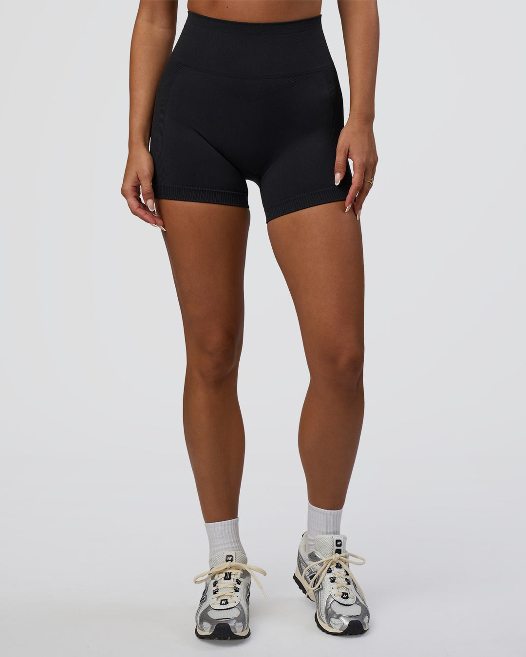 Woman wearing Surge Seamless High-Rise 4" Short - Black | Model:Bianca | Size:S