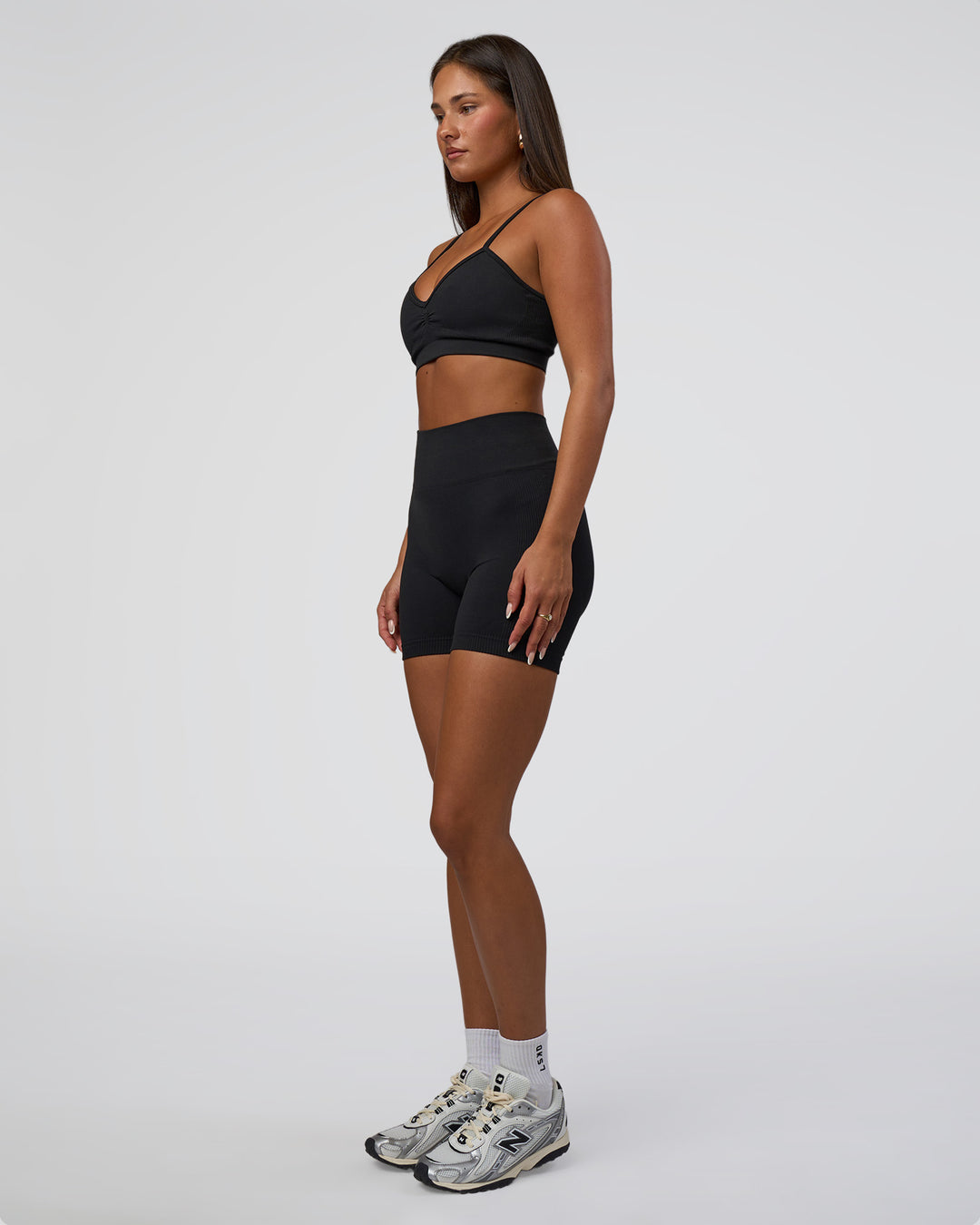 Woman wearing Surge Seamless High-Rise 6" Short - Black | Model:Bianca | Size:S
