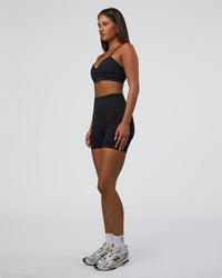 Woman wearing Surge Seamless High-Rise 6" Short - Black | Model:Bianca | Size:S