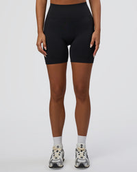 Woman wearing Surge Seamless High-Rise 6" Short - Black | Model:Bianca | Size:S