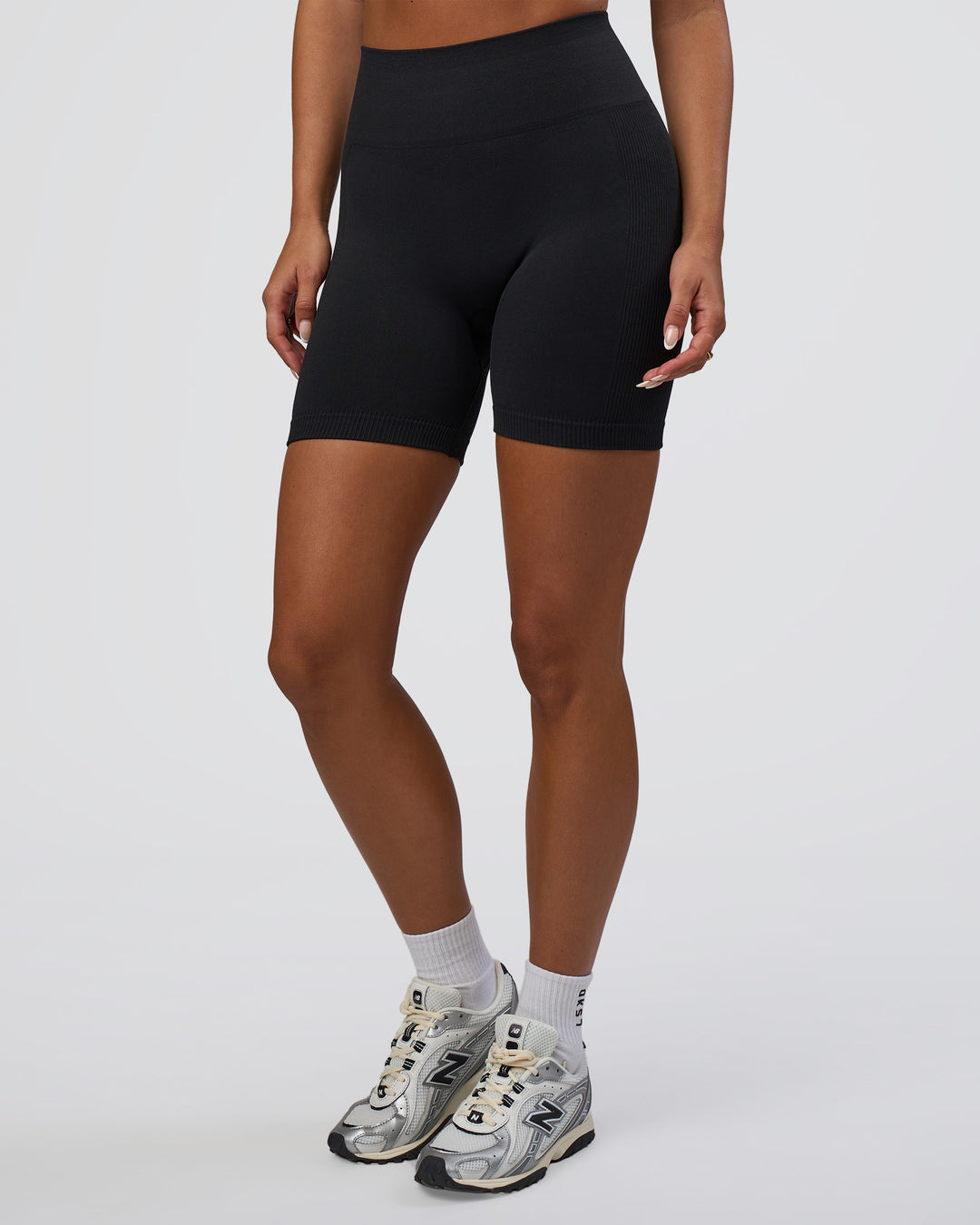 Woman wearing Surge Seamless High-Rise 6" Short - Black | Model:Bianca | Size:S