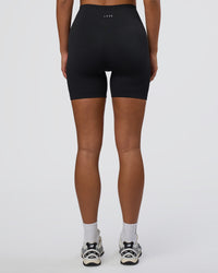 Woman wearing Surge Seamless High-Rise 6" Short - Black | Model:Bianca | Size:S