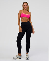 Woman wearing Tempo Sports Bra - Ultra Pink-Cantaloupe | Model:Amity | Size:S