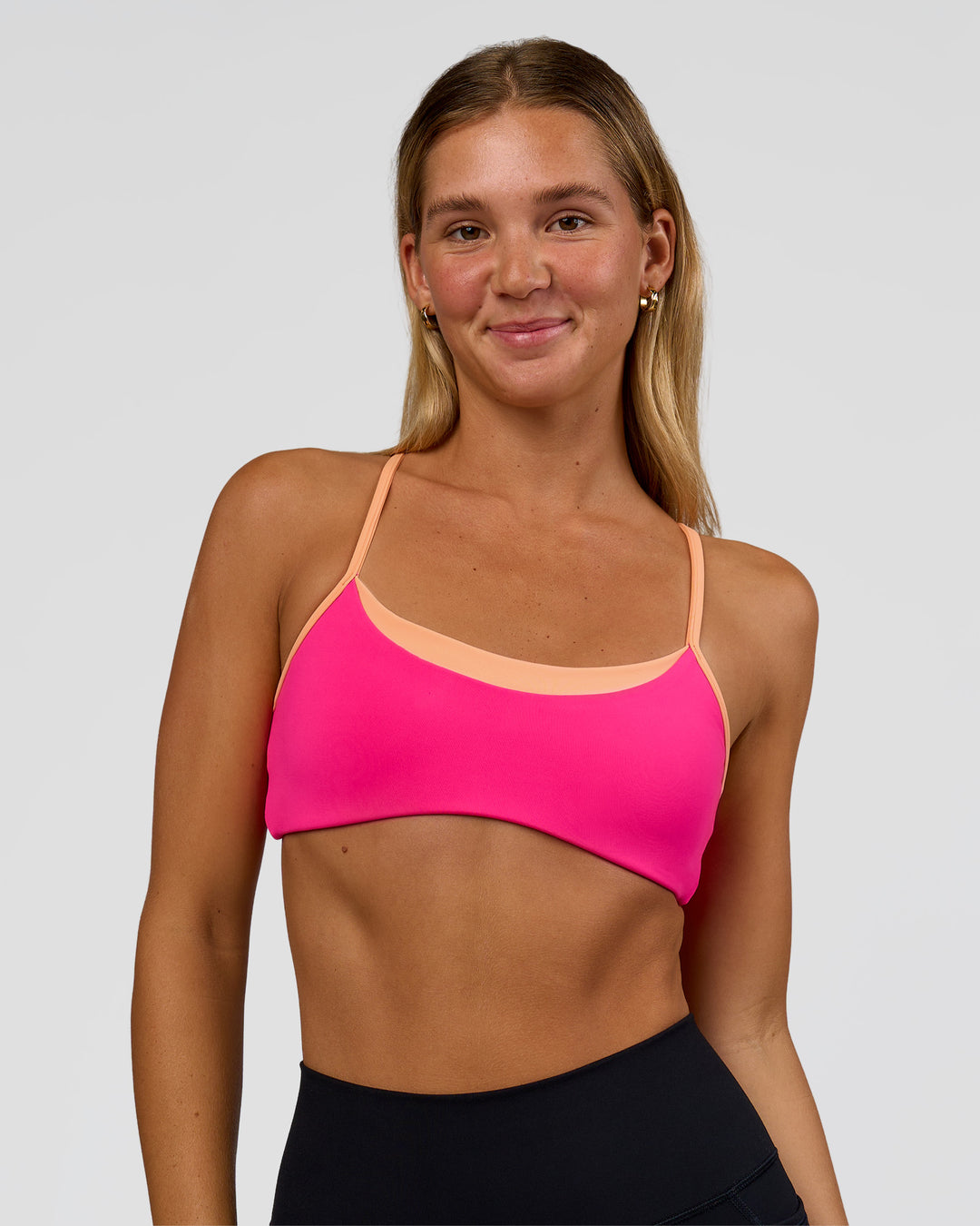 Woman wearing Tempo Sports Bra - Ultra Pink-Cantaloupe | Model:Amity | Size:S