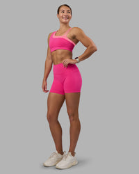 Woman wearing Thrive Asymmetric Sports Bra - Ultra Pink-Candy Pink | Model:Hannah | Size:S