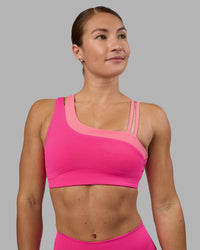 Woman wearing Thrive Asymmetric Sports Bra - Ultra Pink-Candy Pink | Model:Hannah | Size:S
