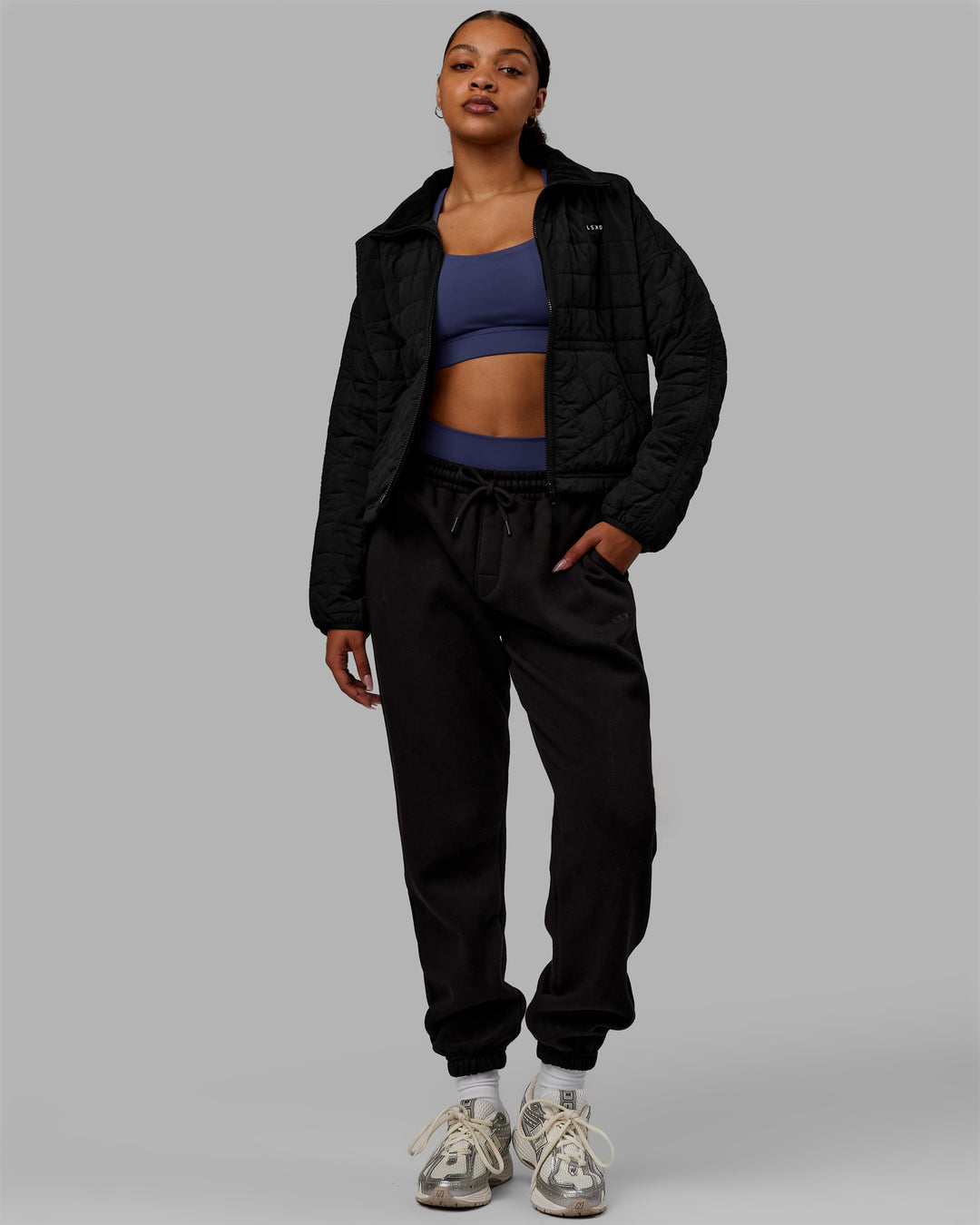 Woman wearing Thrive Packable Jacket - Black