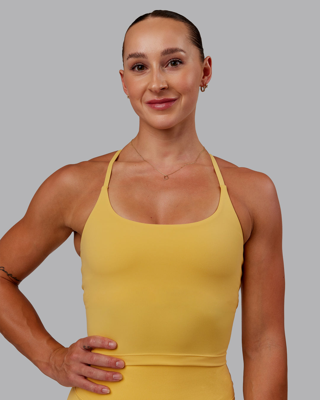Woman wearing Twist Tank With Shelf Bra in Banana Cream | Size:S