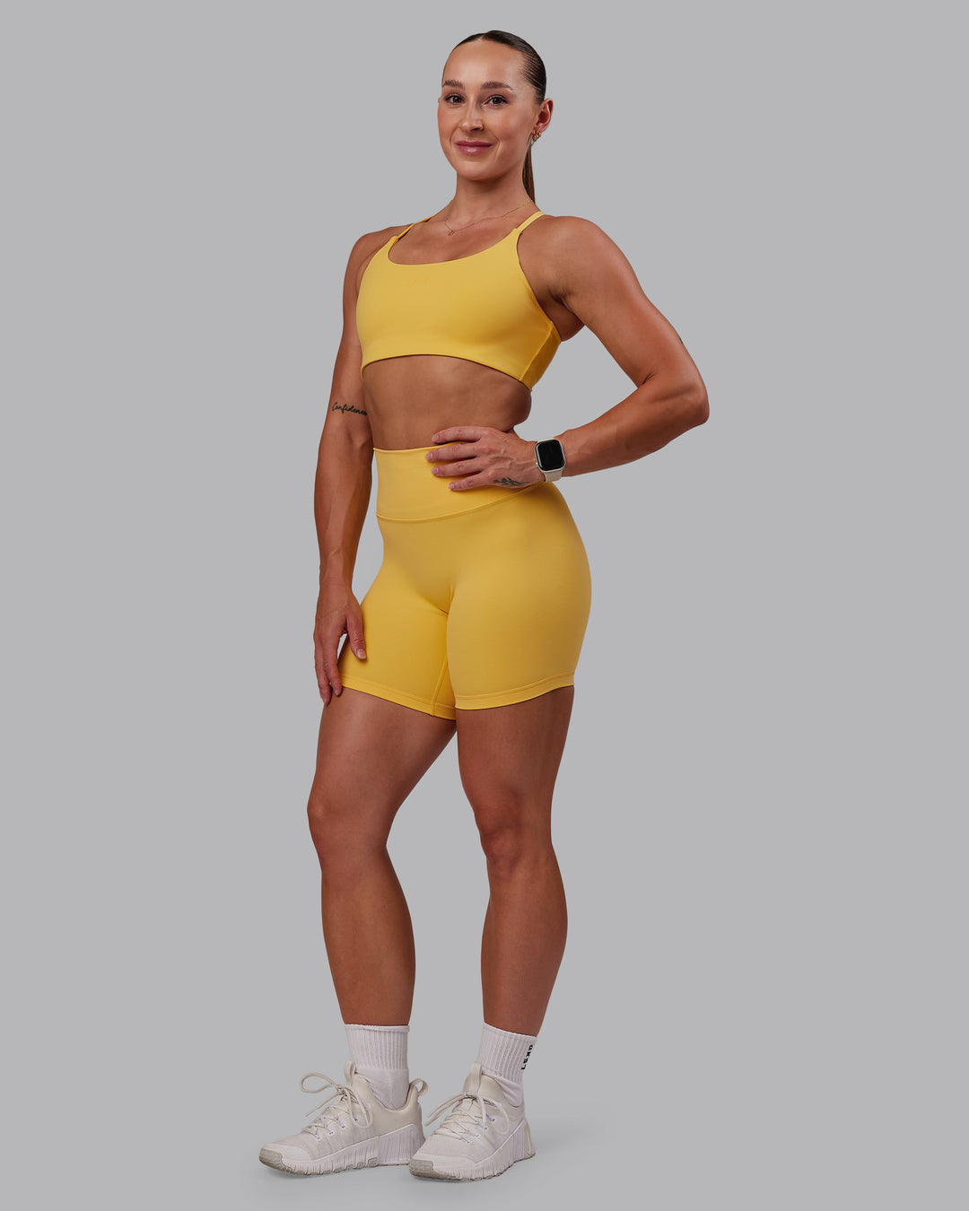 Woman wearing Twist Sports Bra in Banana Cream | Size:S