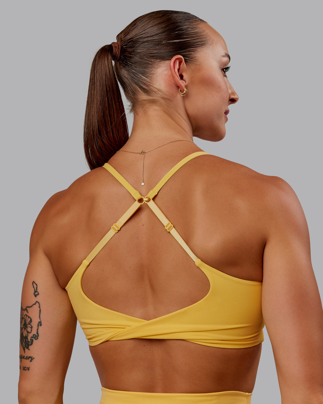 Woman wearing Twist Sports Bra in Banana Cream | Size:S