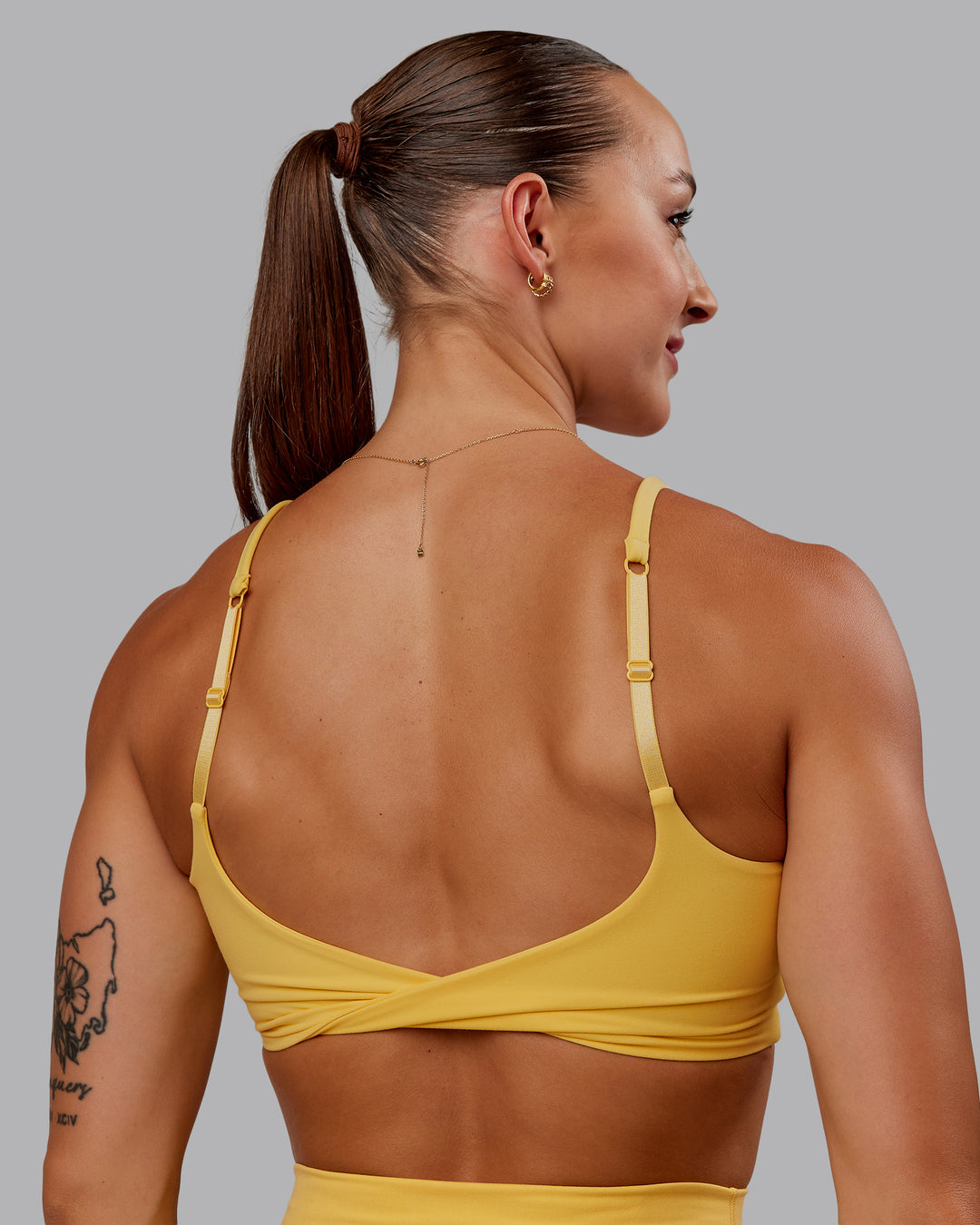 Woman wearing Twist Sports Bra in Banana Cream | Size:S