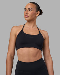 Woman wearing Twist Sports Bra - Black | Model:Sophie | Size:S
