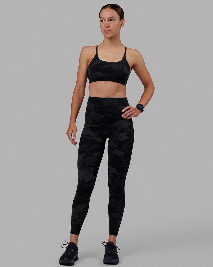 Woman wearing Twist Sports Bra - Black Camo