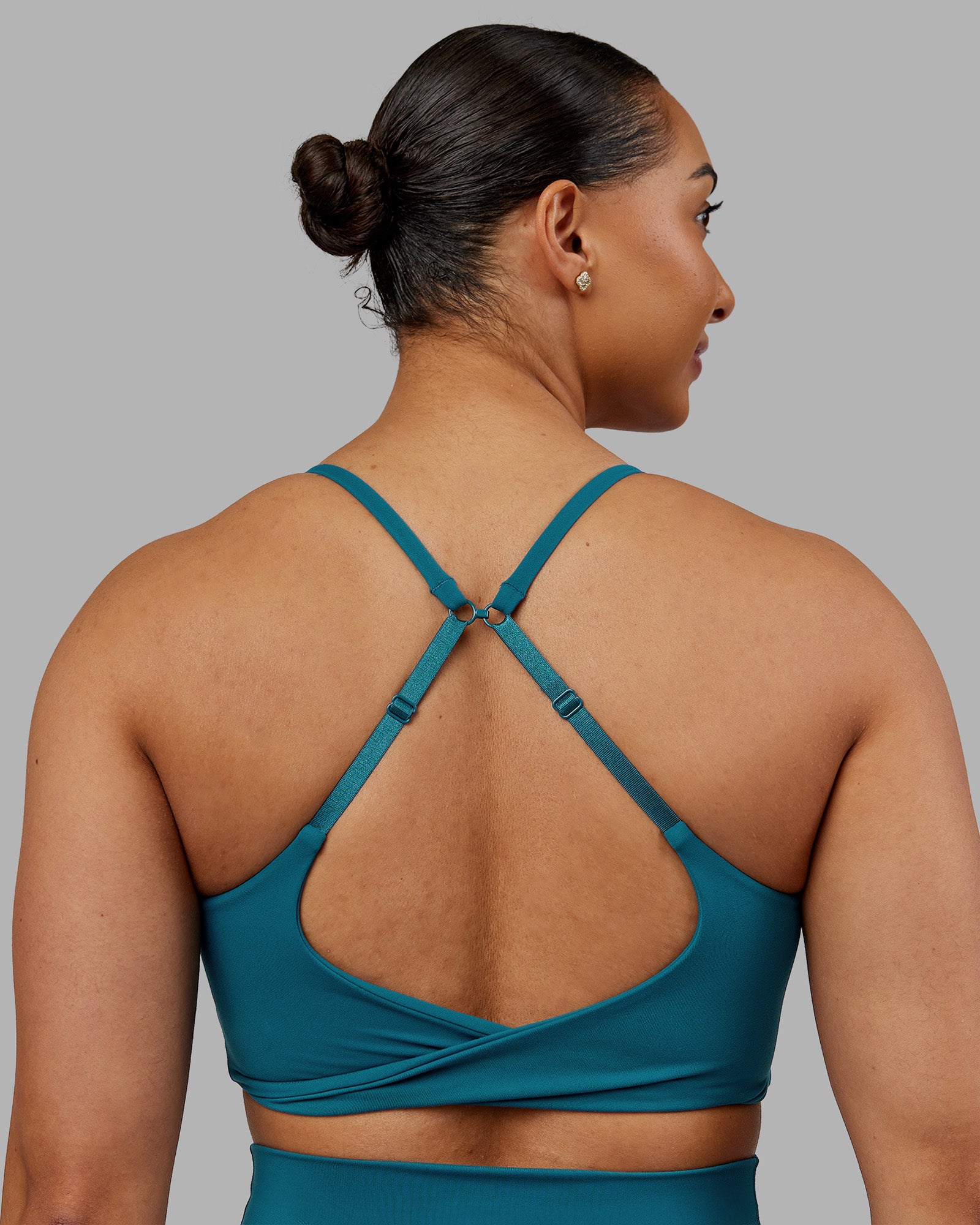 Woman wearing Twist Sports Bra - Blue Coral | Model:Ayla | Size:S