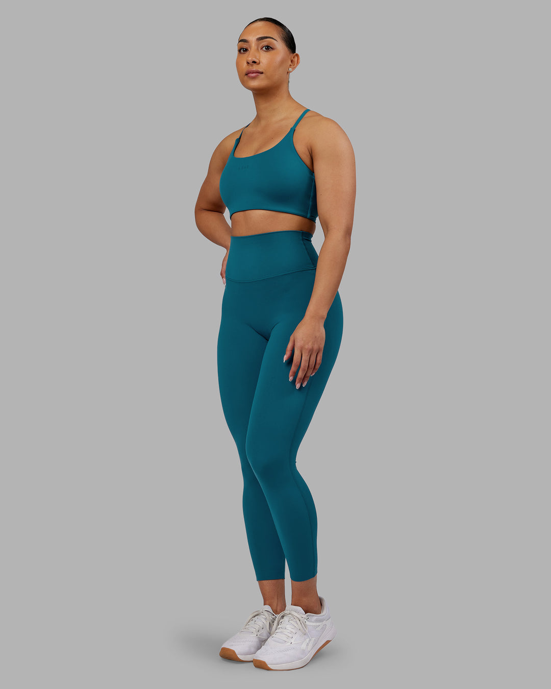 Woman wearing Twist Sports Bra - Blue Coral | Model:Ayla | Size:S