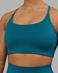 Woman wearing Twist Sports Bra - Blue Coral | Model:Ayla | Size:S