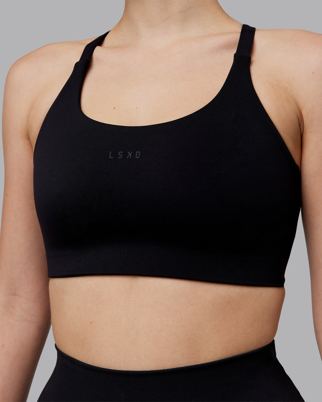 Woman wearing Twist Sports Bra D/DD/E - Black | Model:Lillie | Size:S