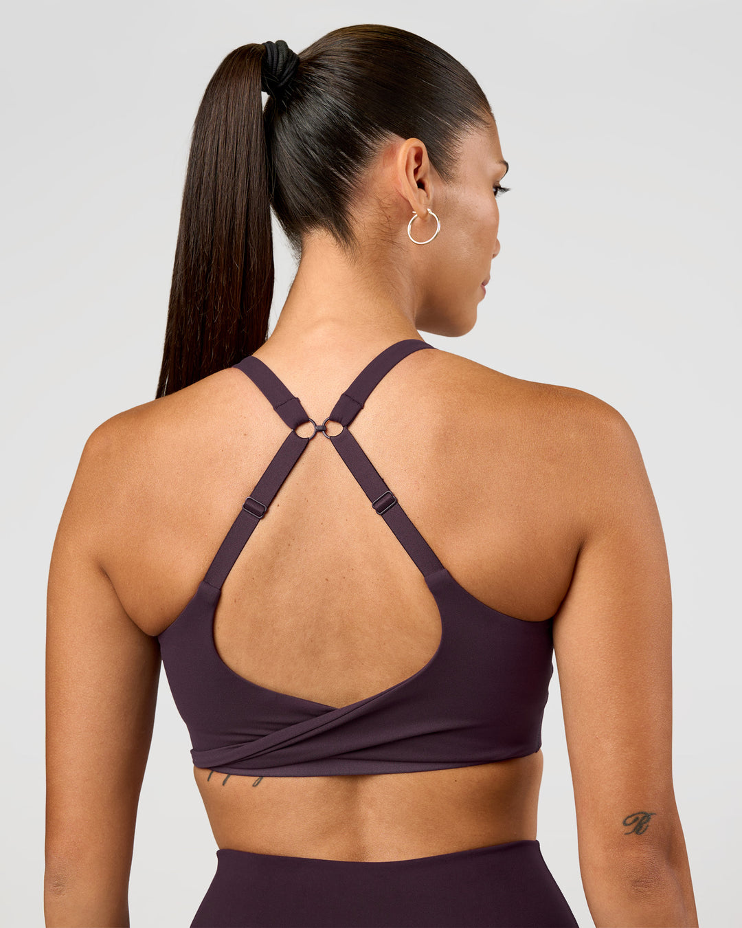 Woman wearing Twist Sports Bra D/DD/E - Midnight Plum | Model:Rhiley | Size:S