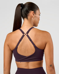 Woman wearing Twist Sports Bra D/DD/E - Midnight Plum | Model:Rhiley | Size:S