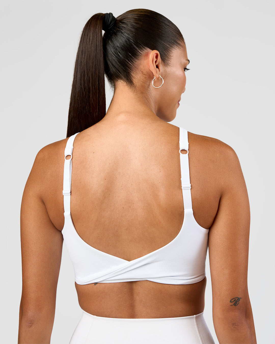 Woman wearing Twist Sports Bra D/DD/E - White | Model:Rhiley | Size:S