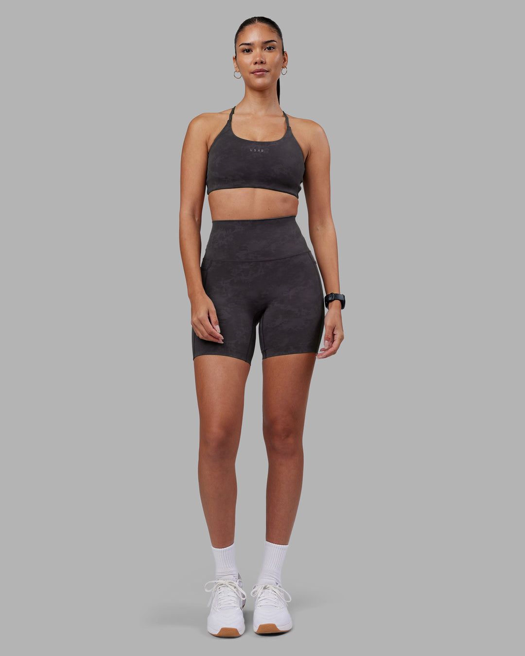 Woman wearing Twist Sports Bra - Dark Storm Wash | Model:Rhiley | Size:S