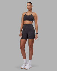 Woman wearing Twist Sports Bra - Dark Storm Wash | Model:Rhiley | Size:S