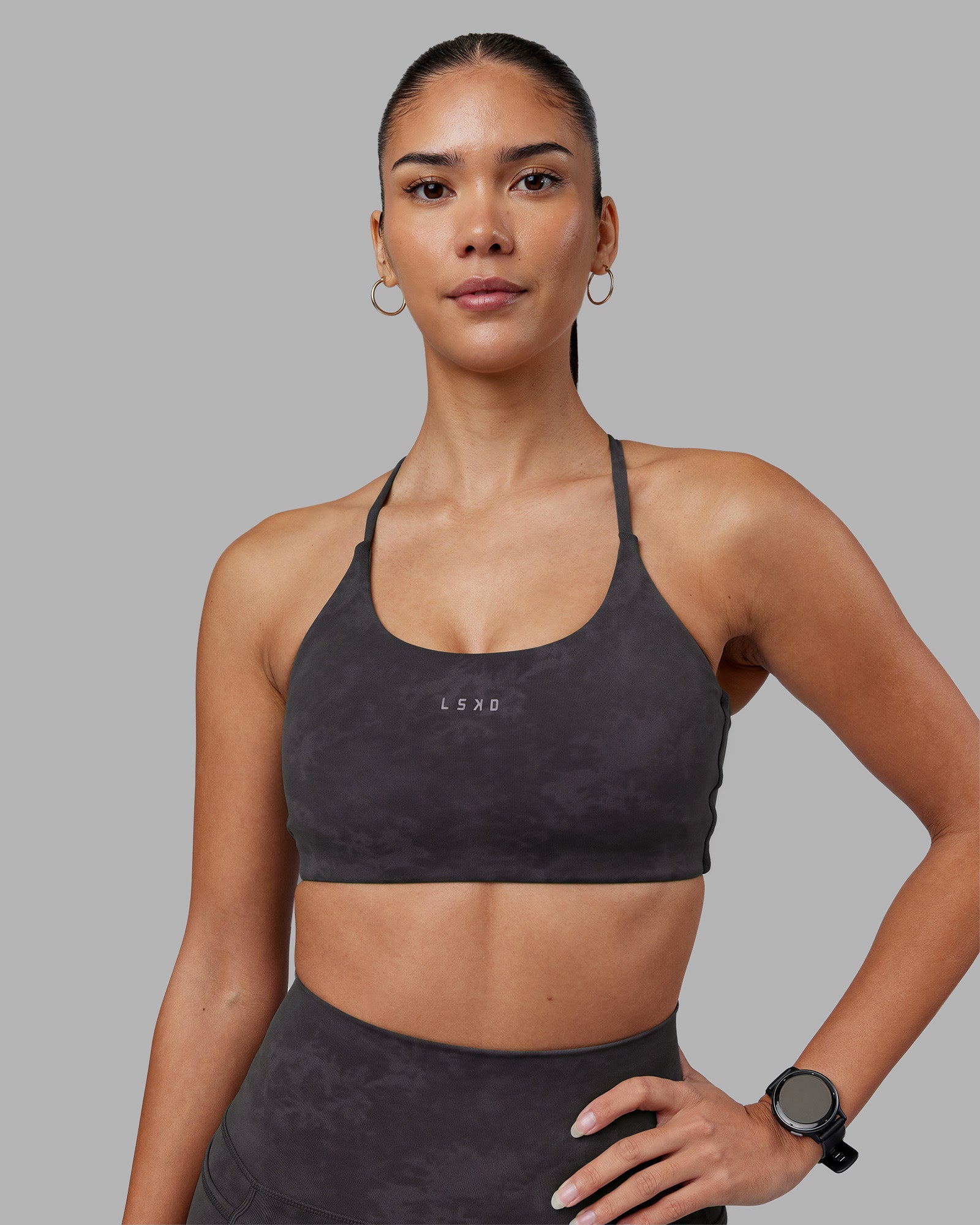Woman wearing Twist Sports Bra - Dark Storm Wash | Model:Rhiley | Size:S