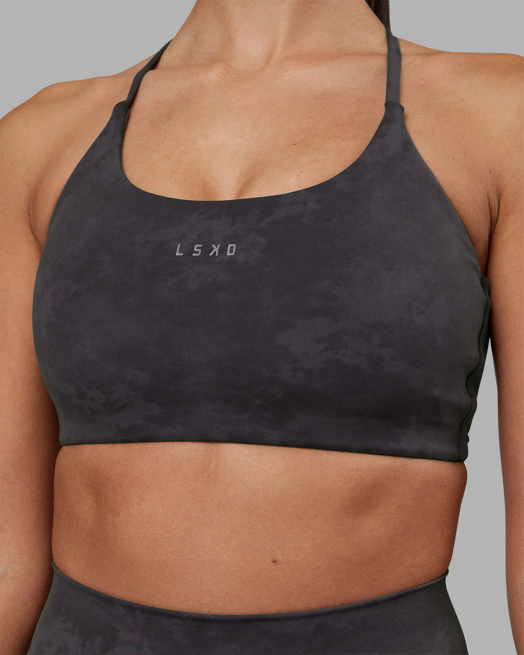 Woman wearing Twist Sports Bra - Dark Storm Wash | Model:Rhiley | Size:S