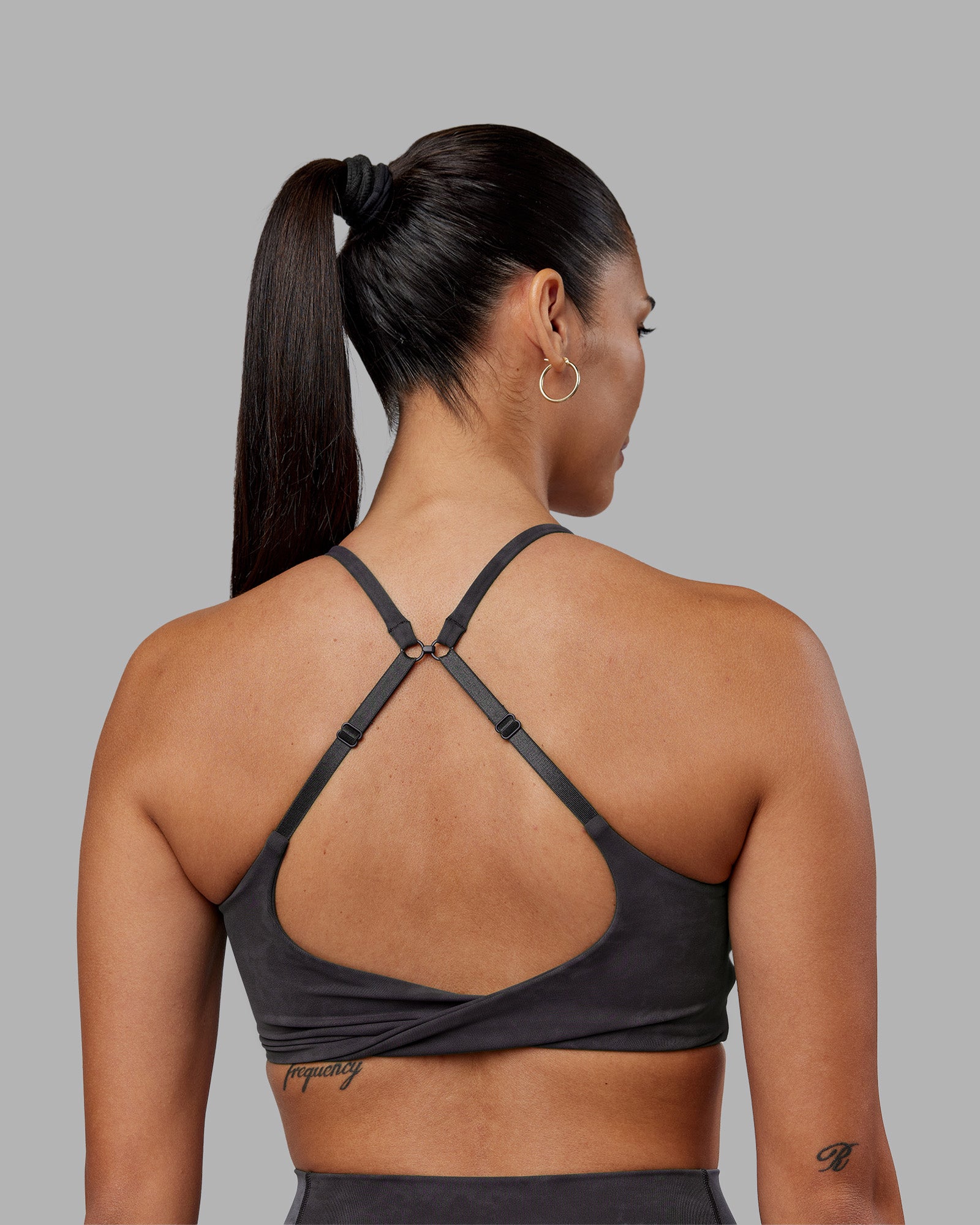 Woman wearing Twist Sports Bra - Dark Storm Wash | Model:Rhiley | Size:S