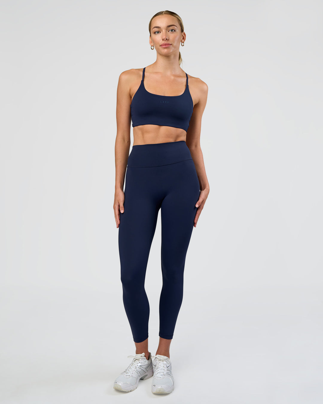 Woman wearing Twist Sports Bra - Future Navy | Model:Evie | Size:S