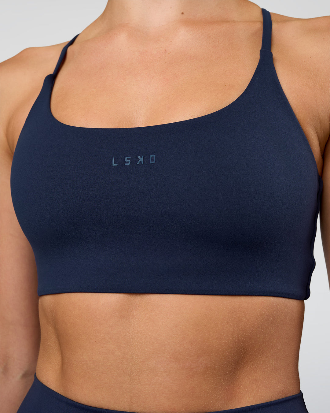 Woman wearing Twist Sports Bra - Future Navy | Model:Evie | Size:S
