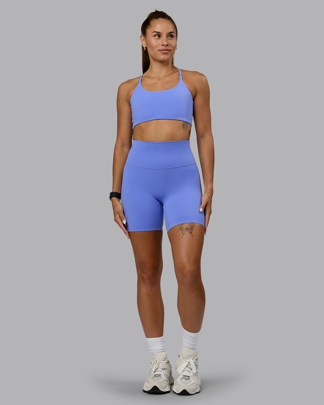 Woman wearing Twist Sports Bra - Indulgent Blue